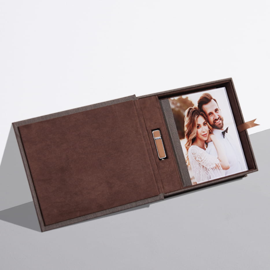 a presentation box album usb set leaning against a wall showing a couple