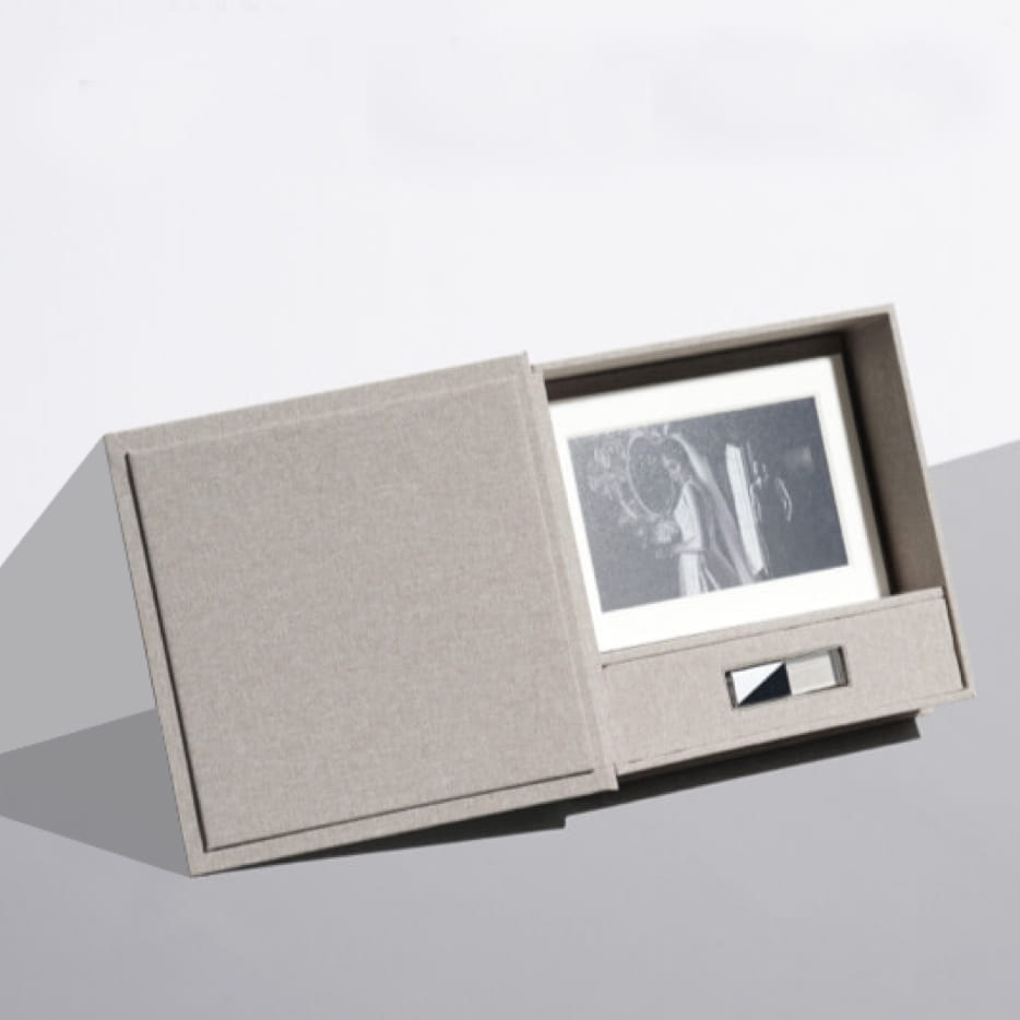 a folio box prints usb set leaning against a wall showing a bride and groom